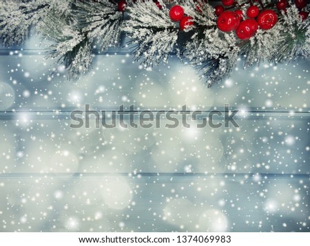 christmas background fir tree branch with cones and snow on wooden blue board