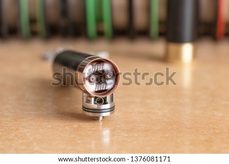 Electronic cigarette. Replacement of old coils in the RDA atomizer. New coils and new cotton are installed in the atomizer.