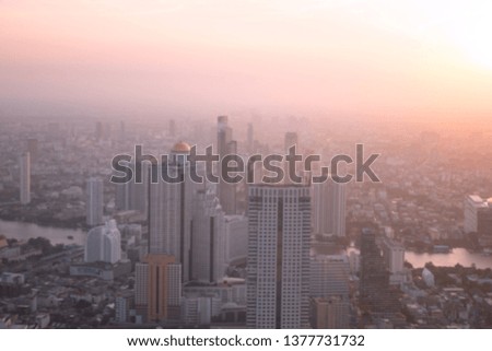 Blurred building/Background of cityscape concept: Blurred aerial view building big city on amazing golden warm light at sunrise /