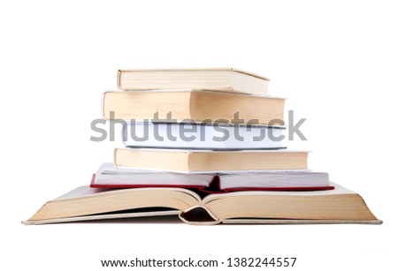 Stack of open and closed hardback cover books isolated on white background.