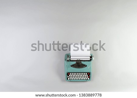 blue typewriter on blank background
