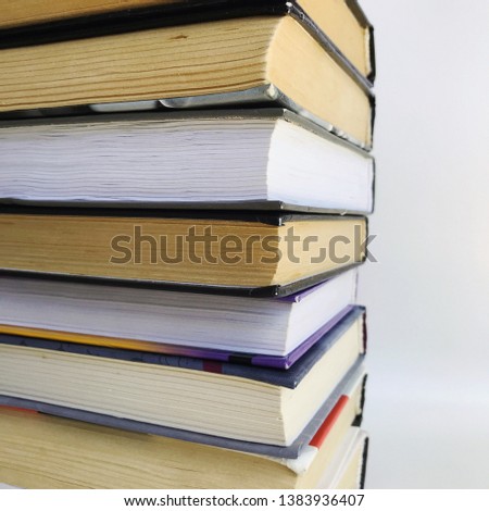 background with books. A stack of books on a white background. Old books lie on top of each other. Roots of old books.