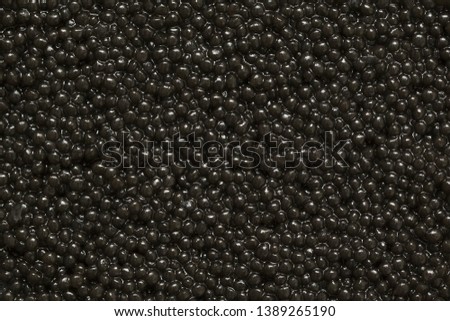 Black caviar close-up as a background. Texture of black caviar