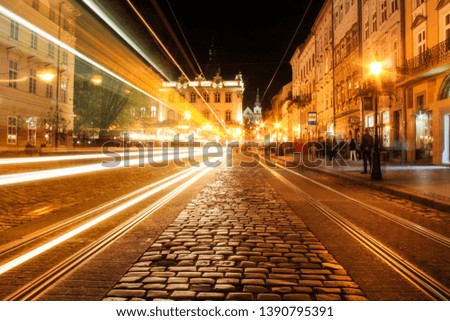 Lviv panorama at night. View of the night street of the European medieval city. Lviv Market square at night.  Concept  - travel, landmarks. FROZEN LIGHT FROM TRAM. Long exposure