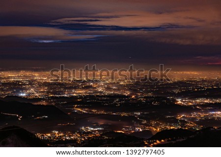 View of city lights from the top of a mountain