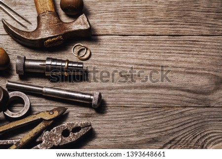 Tools for the repair of jewelry on a wooden table with copy space, top view