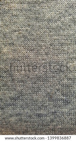 A full page of soft grey knitted sweater background texture. Textile texture as background for design-works.