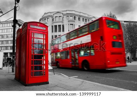 London, the UK. Red phone booth and red bus in motion. English icons