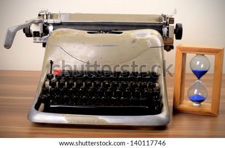 Old typewriter and hourglass