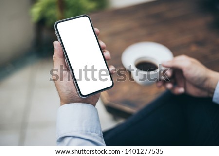 Mockup image man hand holding texting using mobile,cell phone with copy space,white blank screen for text.concept for contact business,people communication,technology electronic device