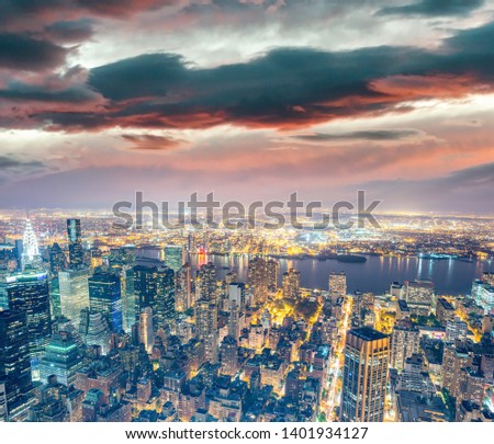 Night aerial view of Midtown Manhattan skyline from a New York City rooftop..