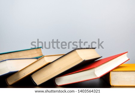 Stack of old books on shelf book on gray background.Education learning and reading concept.
