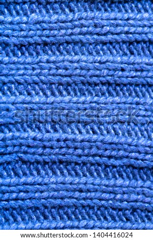 Background texture of sky blue rib or cable stitch pattern knitted fabric made of cotton or wool. closeup.