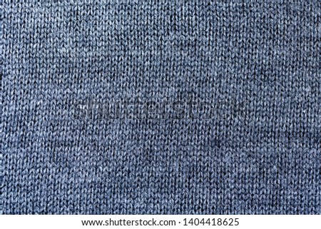 Background texture of grey pattern knitted fabric made of cotton or wool closeup
