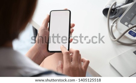 Smartphone with Blank screen in the hand of female doctor