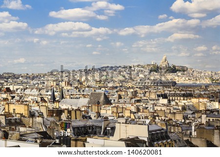 View at Paris from one of the central rooftops. Sacre-coeur basilica is visible on the horizont.