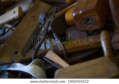 Old tools in a wooden crate. Planers, pliers, drills, hammers and other joinery needs.