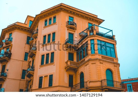orange building with big glass balcony in mediterranean style