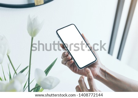 Mockup image woman hand holding texting using mobile,cell phone with copy space,white blank screen for text.concept for contact business,people communication,technology electronic device 