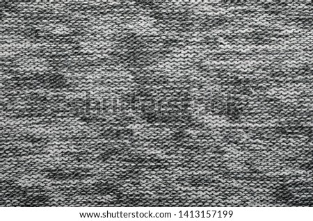 Grey melange knitted fabric made of heather mixed yarn textured background