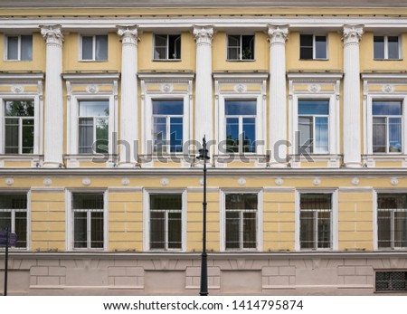 Vintage architecture classical yellow white facade. Front view close up.