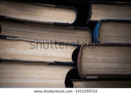Color image of a pile of old books.