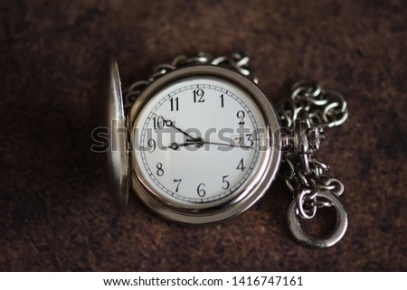 Old pocket watch on dark background