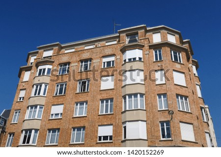 
Brick building with white shutters.