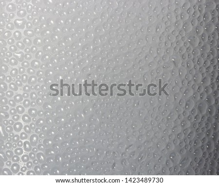 Drops of condensate on the surface of a plastic bottle, close-up