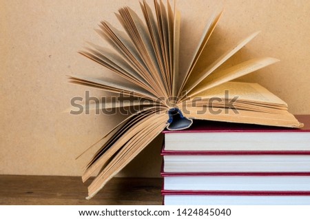 open book in hardcover. Back to school. Wooden background