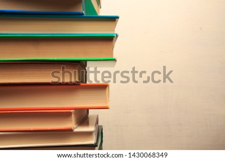 Book stack in the library room and blurred bookshelf for business and education background, back to school concept - Image 