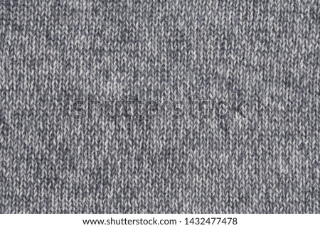 Grey woolen knitted texture with vertical stitching. Part of sweater.