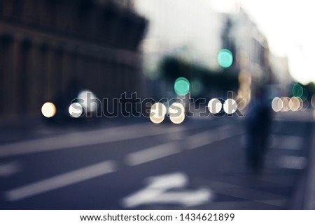 Blurred abstract background depicting the evening streets of the city with the movement of cars with burning lights and traffic lights