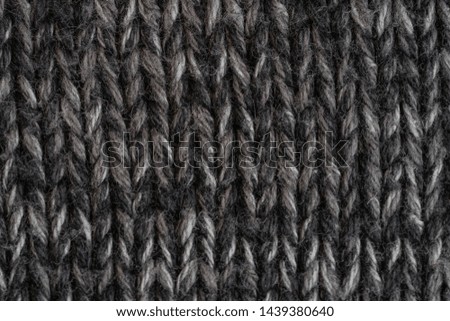 Texture knitted fabric. Warm sweater made of different color yarn. Creative vintage background