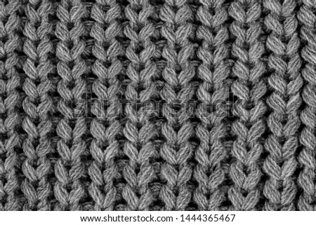 Close up gray cotton fabric texture background. 
Macro Black and white textured knit fashion fabric background. 
Selective focus. top view. 
