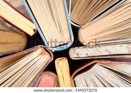 Pile of old books, close up top view school background