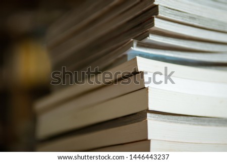 tall stack of paperback books
