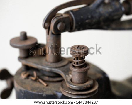 Detail view of an old rusty machine with bolt