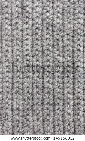 Knitted woolen background of gray color