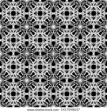 Seamless abstract pattern. Imitation lace. White lace on black background. Black and white graphics. For design and decoration of fabric, paper, Wallpaper and packaging.Mesh pattern.