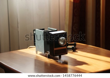 Film-viewing device slide projector lay on the table.