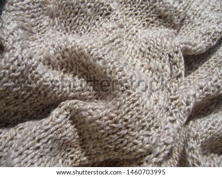 Wool knitted fabric. Light textile background.