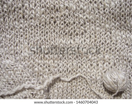 Wool knitted fabric. Light textile background.