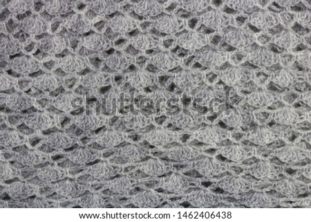Homemade knitted warm woolen gray  scarf wrap  texture macro.  Rustic style handcraft  concept