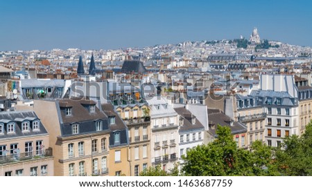 Paris, panorama of the city, typical roofs and buildings, with Montmartre and the Sacre-Choeur basilica in background
