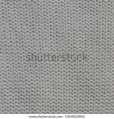 Handmade white knitting wool fabric texture. Background of abstract knitting patterns.