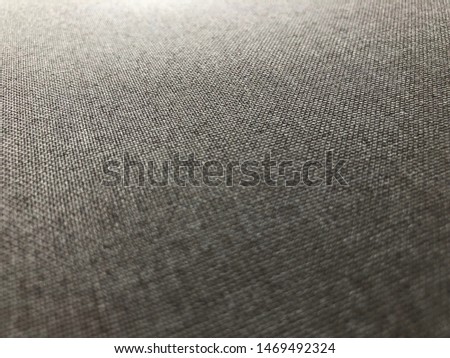 Closeup grey fabric with faded lighting.