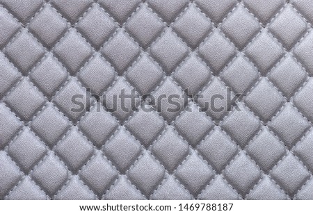 Faux leather with embossed silver color. Background texture, top view. Close-up