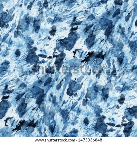 Seamless tie-dye pattern of indigo color on white silk. Hand painting fabrics - nodular batik. Shibori dyeing. 