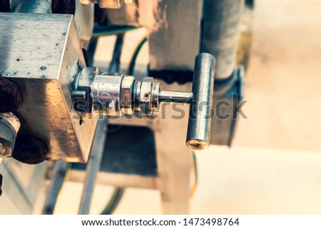 detail of actuator, small manual valve in metal for supplying air to instruments of an industrial plant